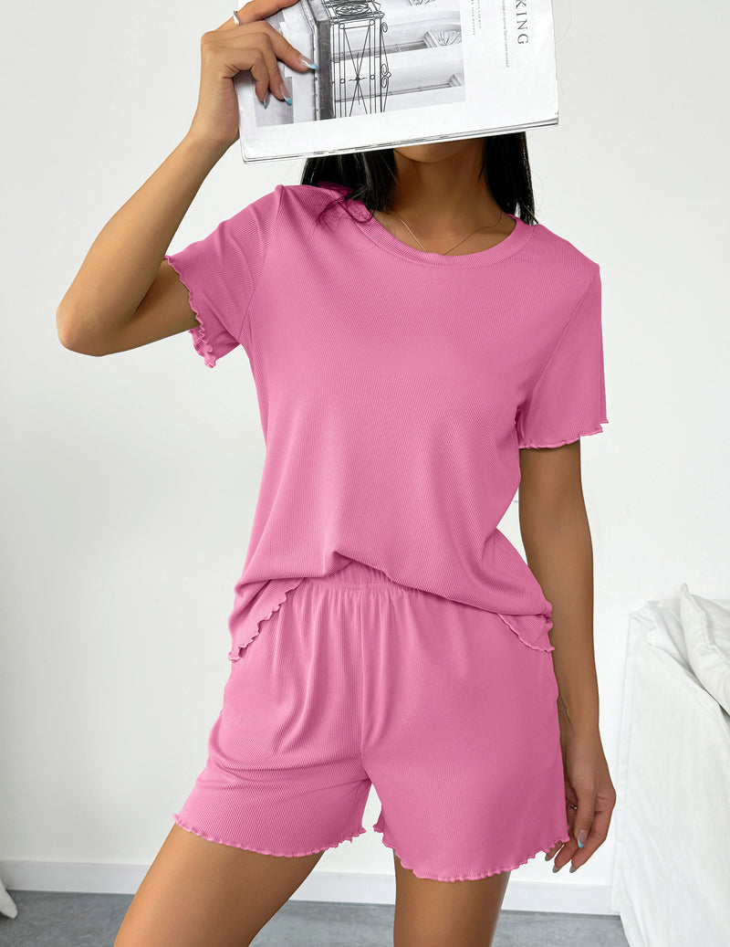 Pink short sleeve pajama set with elastic-waist shorts and ruffled hem