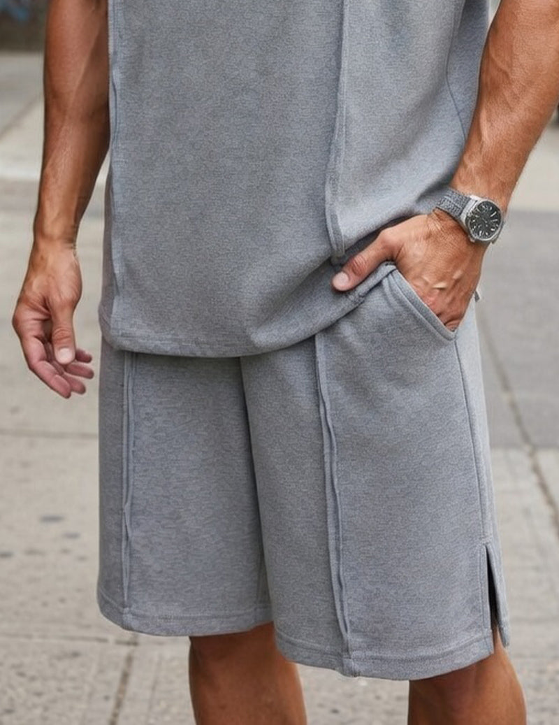 Grey cargo shorts with side slit detail; matching oversized sleeveless tank top