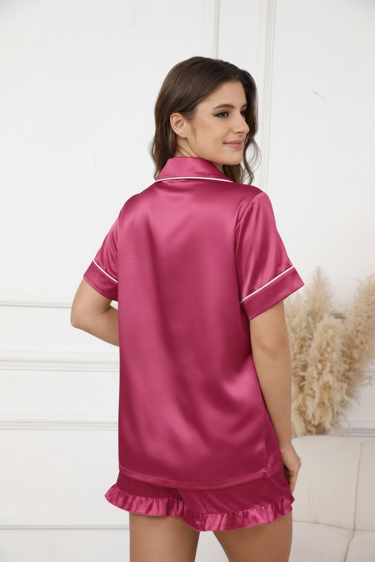 Women's satin pajama set in pink: short-sleeve button shirt with ruffled hem, white trim