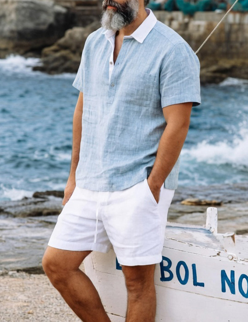 Light blue camp-collar cotton shirt with white drawstring shorts, front