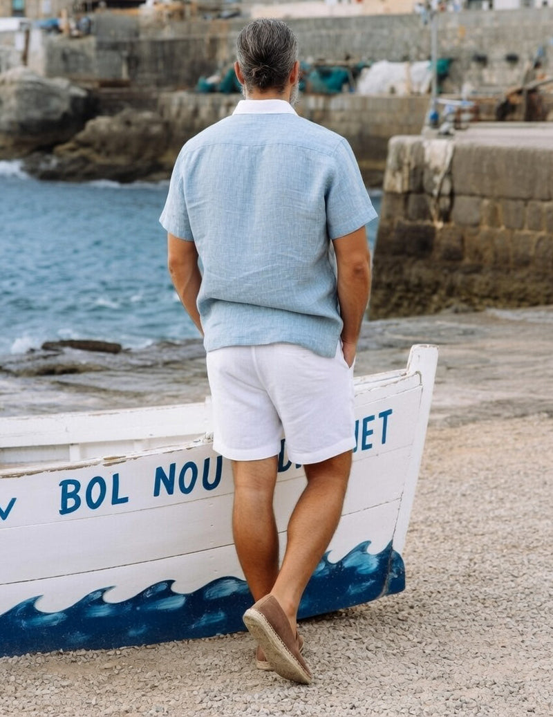 Back view: light blue camp-collar shirt with white drawstring shorts