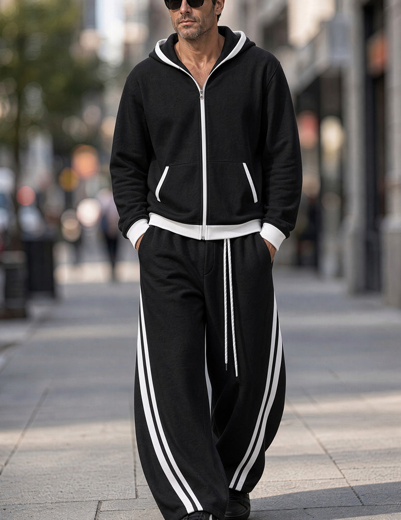Black tracksuit set with zip hoodie, white piping, and striped joggers