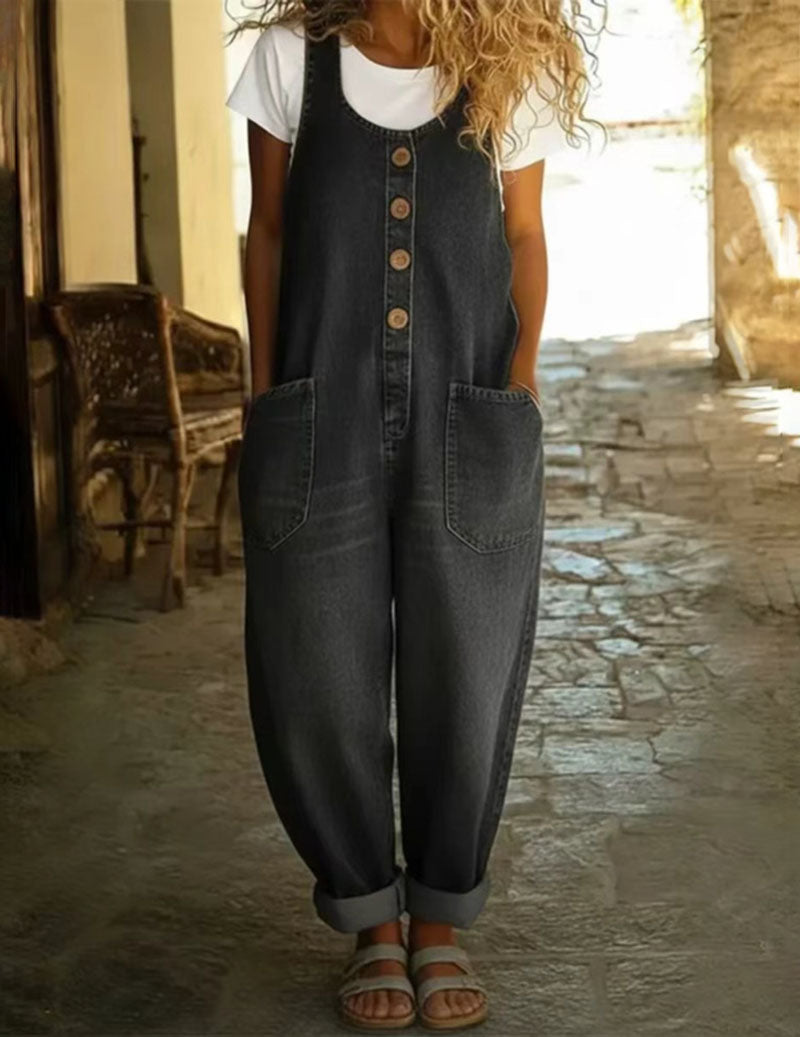 Black sleeveless denim jumpsuit with button front and front patch pockets, wide legs