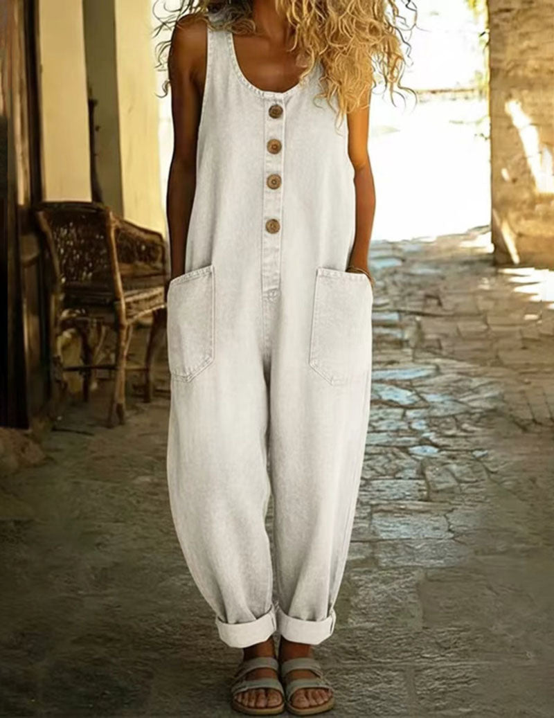 White sleeveless denim jumpsuit with button front and two front patch pockets