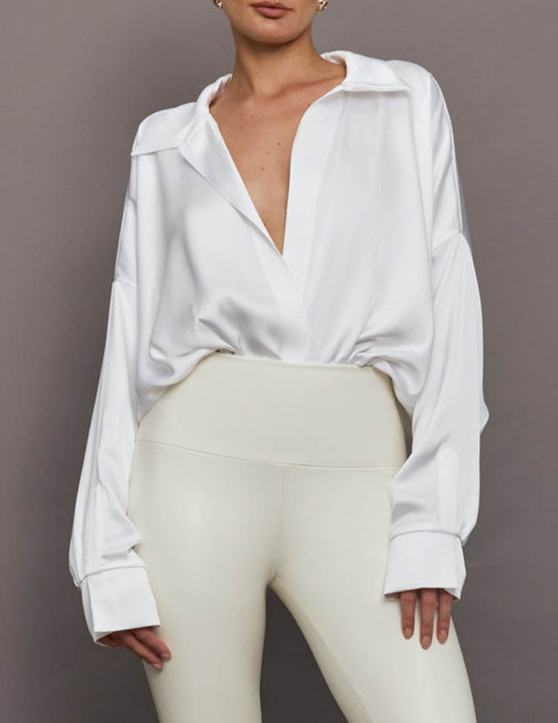 White oversized collared long-sleeve shirt bodysuit with deep V neckline