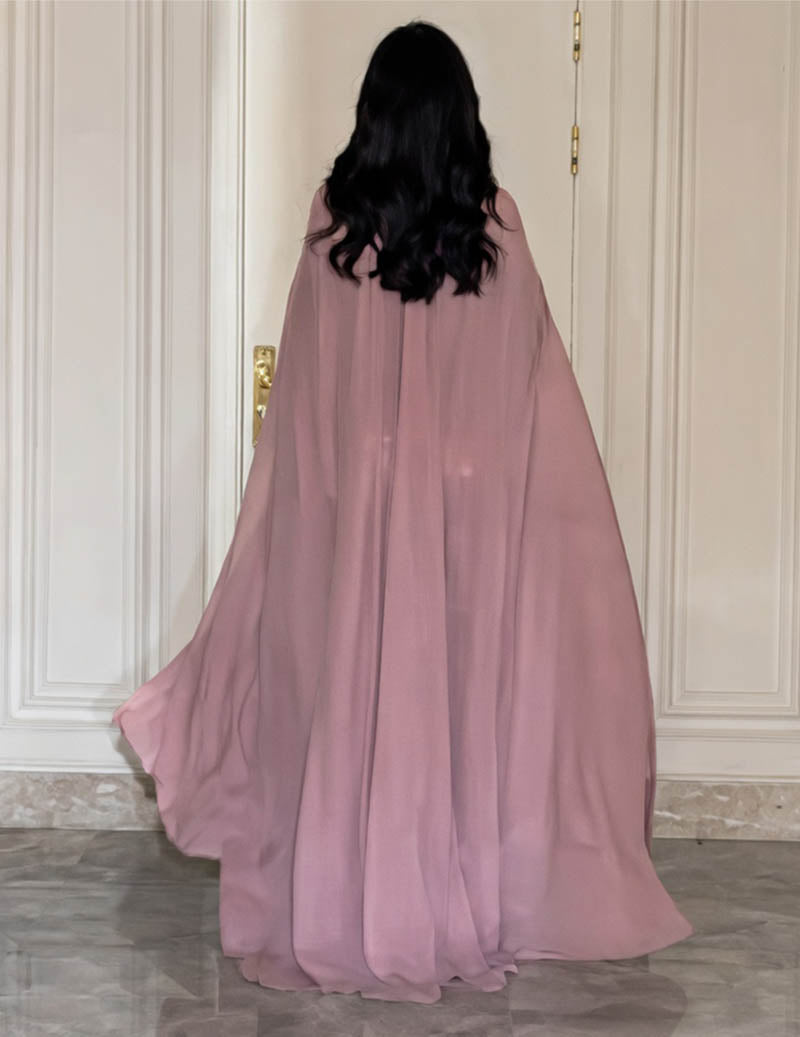 Back view of pink high-neck beaded cape evening gown with flowing sheer cape