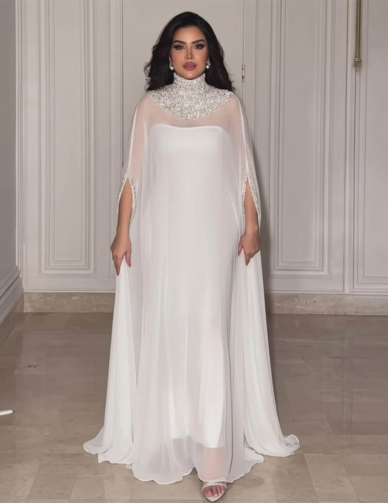 White high-neck evening gown with sparkling beaded collar and cape overlay