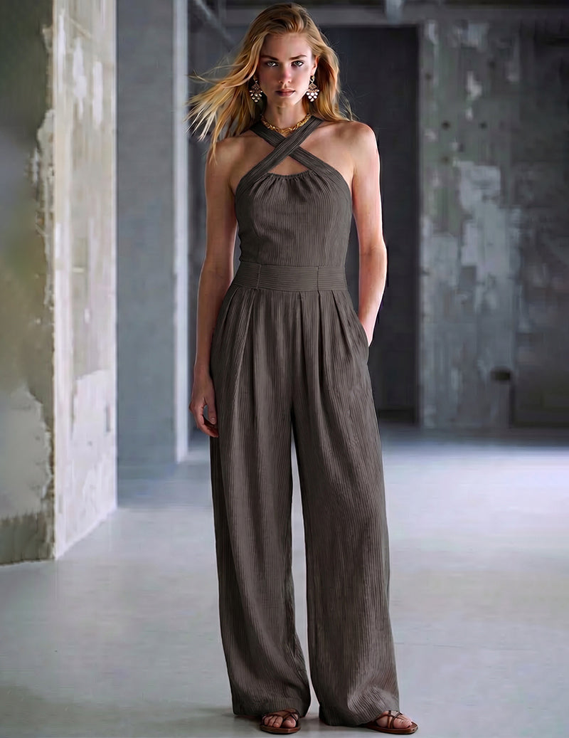 Dark halter jumpsuit with cross-back straps and wide-leg pants