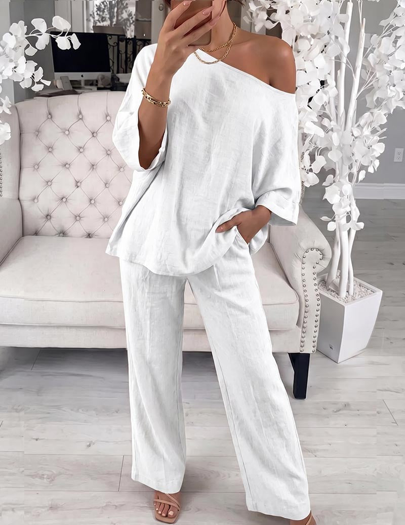 Polyester lounge set in white: off-shoulder loose top and wide-leg pants.