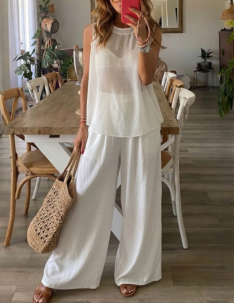 White lounge set with sleeveless tunic top and draped wide-leg pants