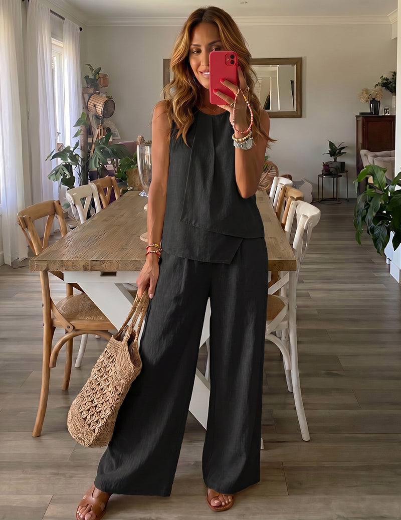 Black sleeveless lounge set with tiered top and wide-leg trousers.