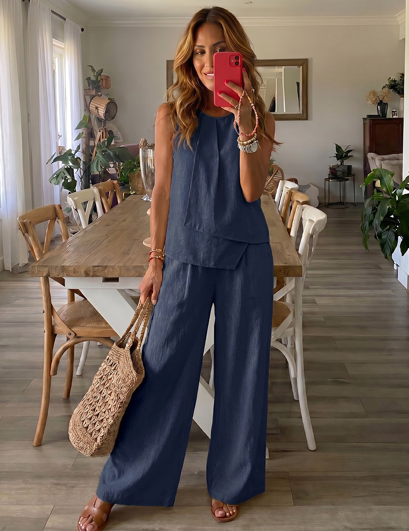 Navy blue sleeveless lounge set with layered top and wide-leg trousers.