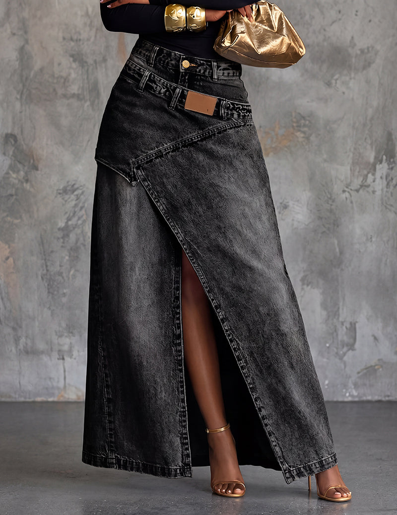 Black denim midi skirt with front slit, pockets, belt loops, and tan waist patch