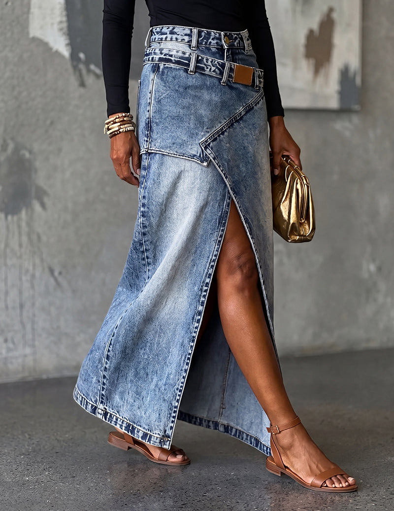 Denim midi skirt in blue with deep front slit, pockets, belt loops, and tan patch