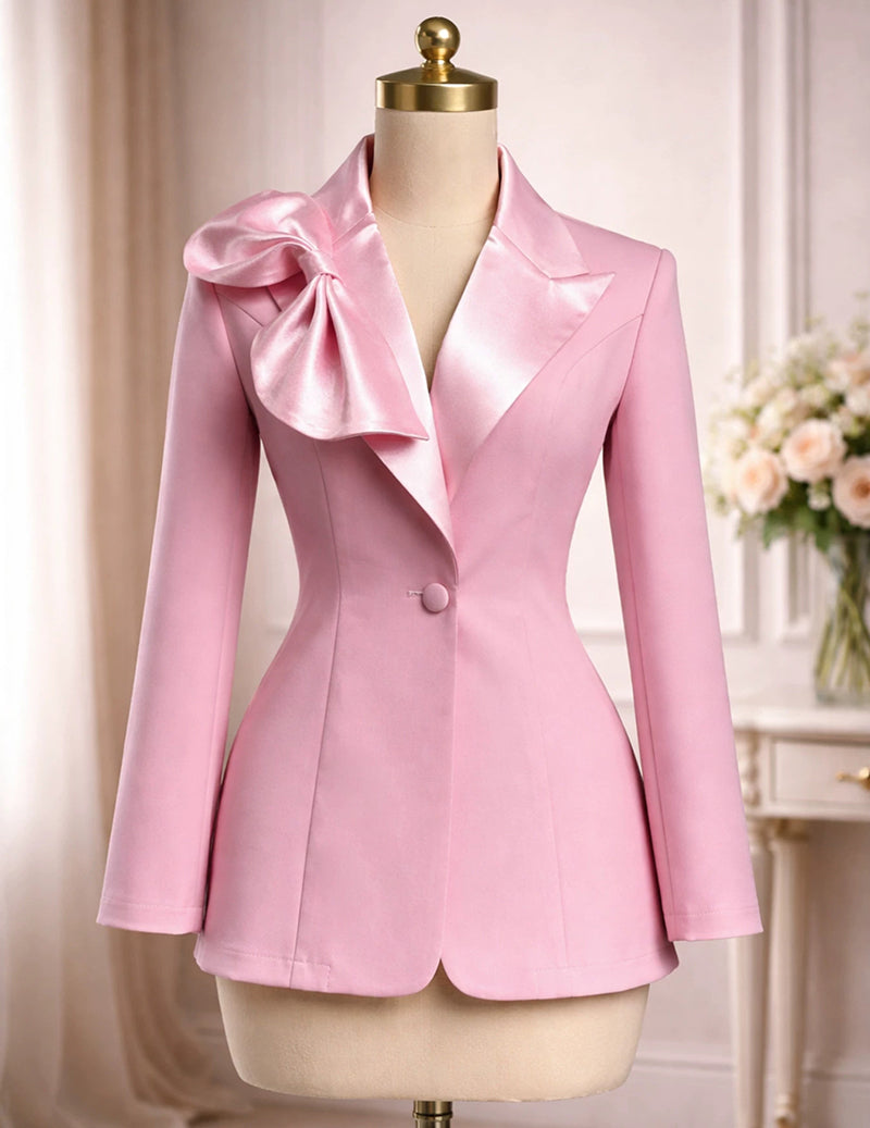 Pink satin blazer on mannequin with bow lapel and front button closure, long sleeves