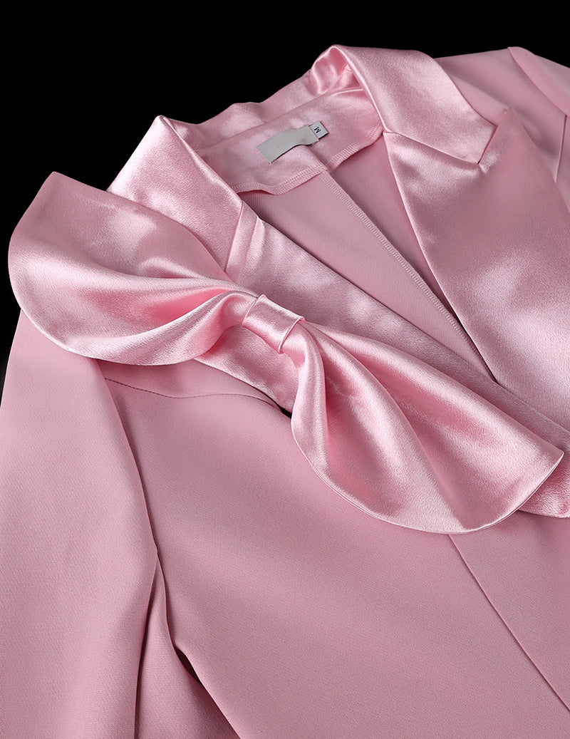 Close-up: pink satin bow on blazer lapel with smooth satin trim