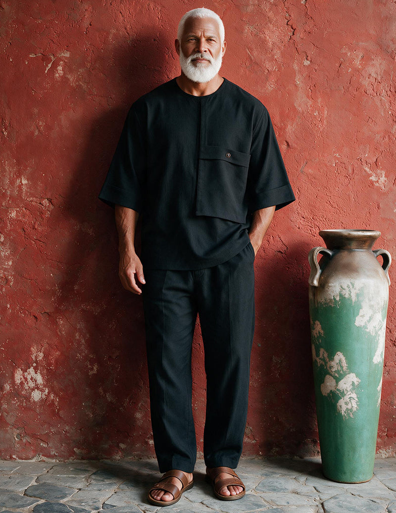 Men's black two-piece loungewear set featuring a patch-pocket shirt and ankle-length pants