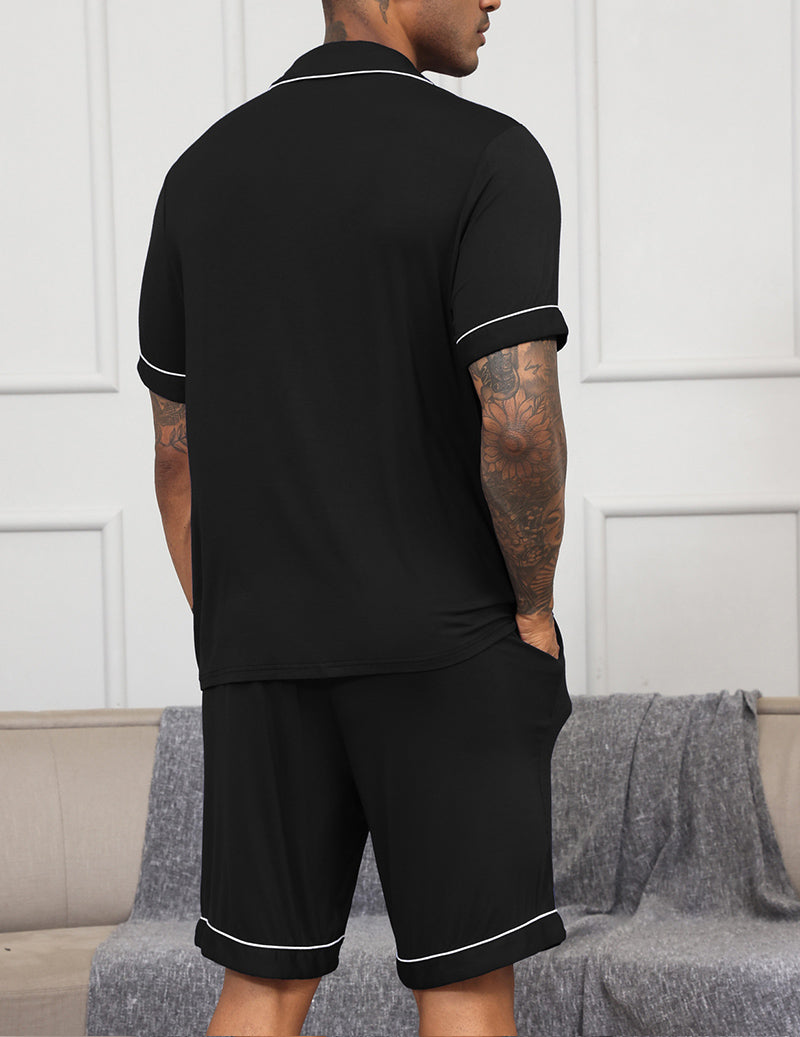 Men's black pajama set, short-sleeve button shirt and matching shorts with contrast trim.