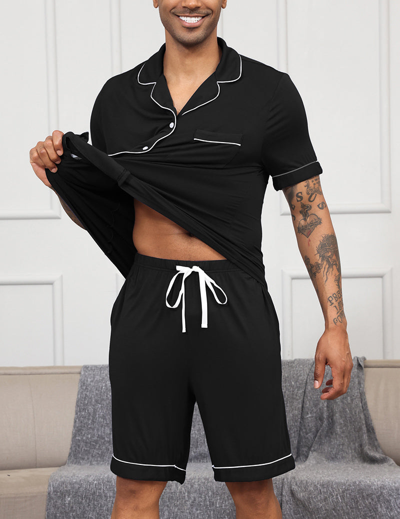 Men's black pajama set with notch collar, button shirt, and drawstring shorts with trim.