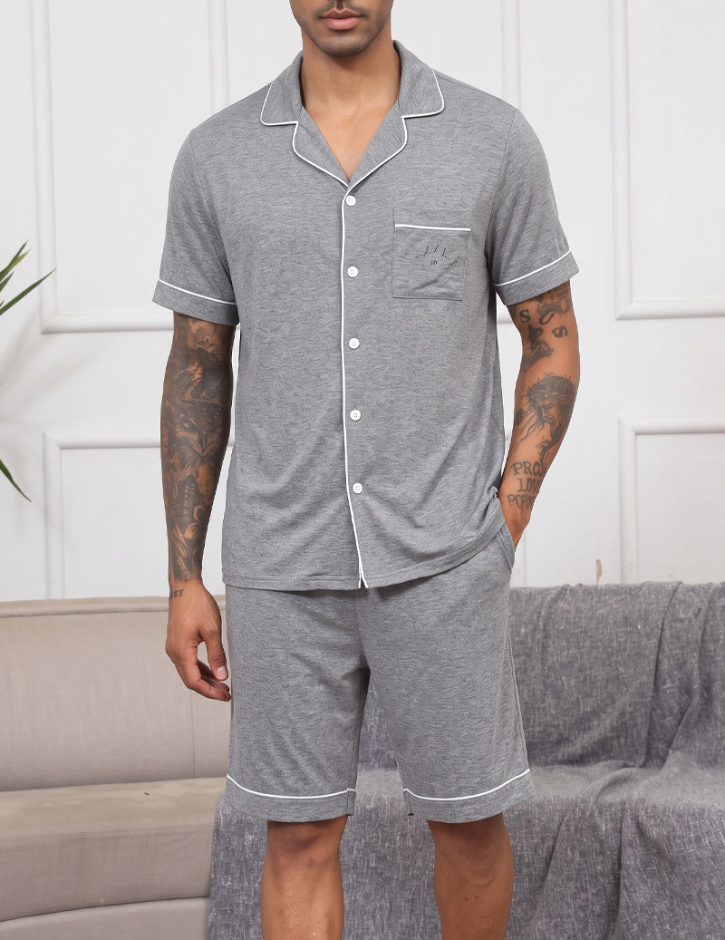 Men's light grey notch-collar short-sleeve pajama set with button front and matching shorts.