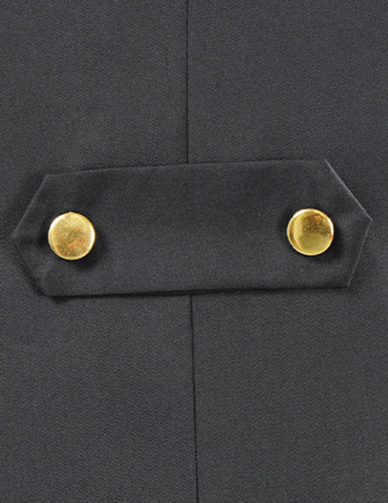 Close-up of black coat pocket flap with gold button detail