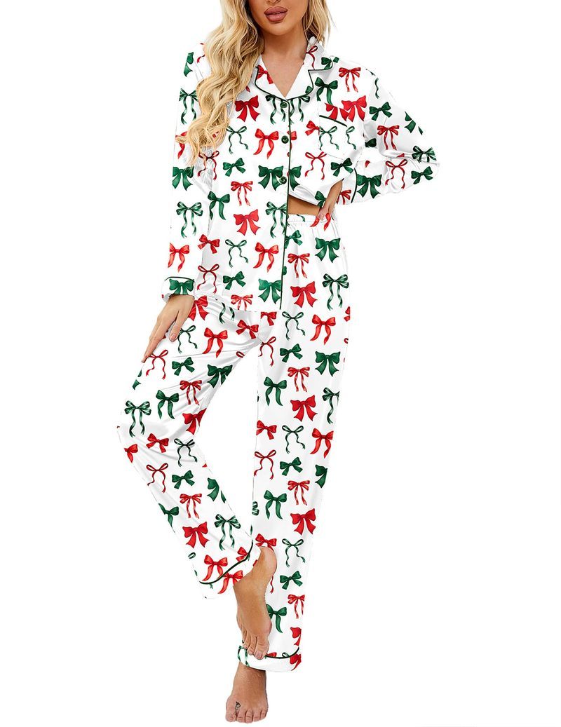White satin pajama set with green and red bow print, button-up top and pants