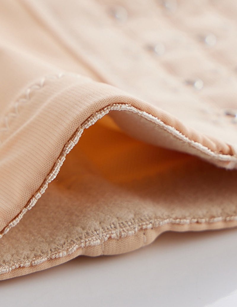 Beige shaper shorts with ribbed outer edge and stitched trim around the leg opening