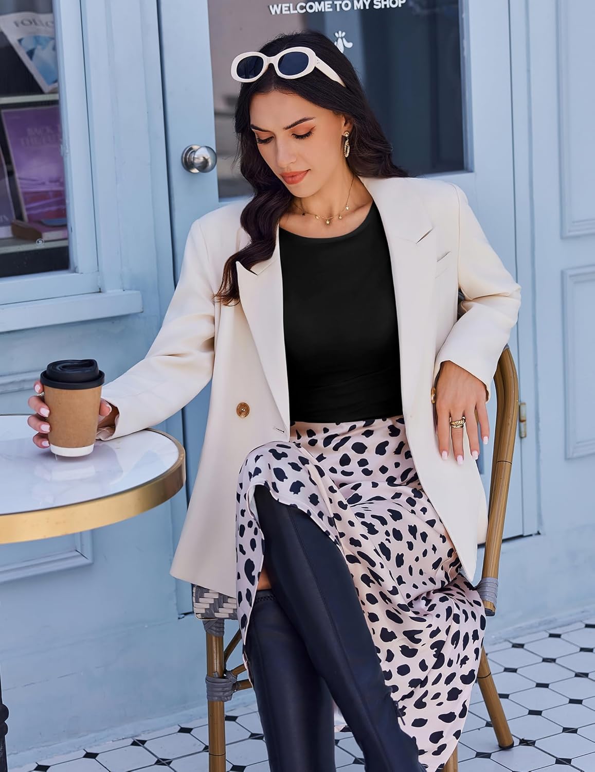 Black boat neck ruched long sleeve top peeking under blazer