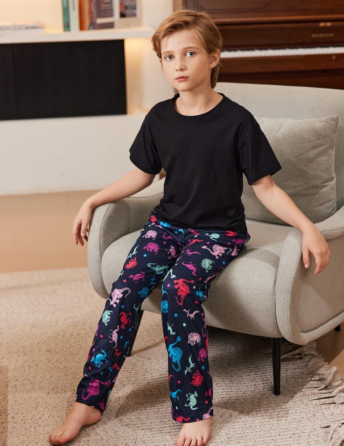 Boys pajama pants with dark background and colorful dinosaur print; elastic waistband.