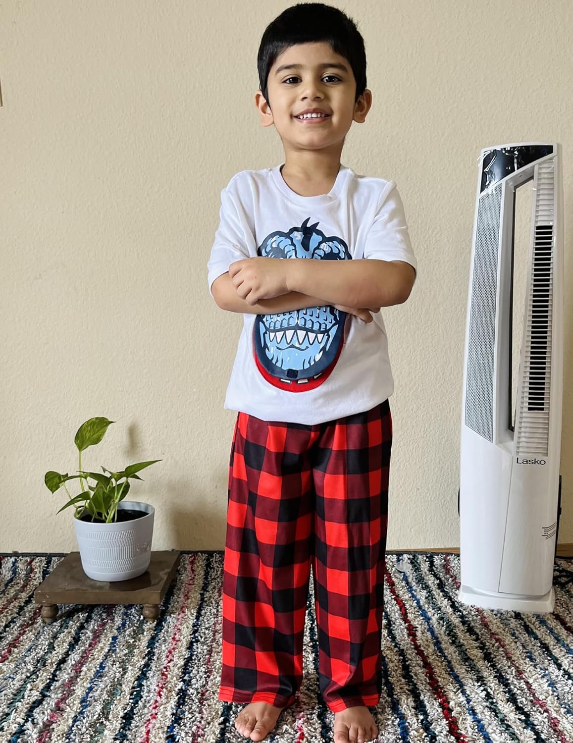 Boys red and black plaid pajama pants with elastic waistband and long straight legs.
