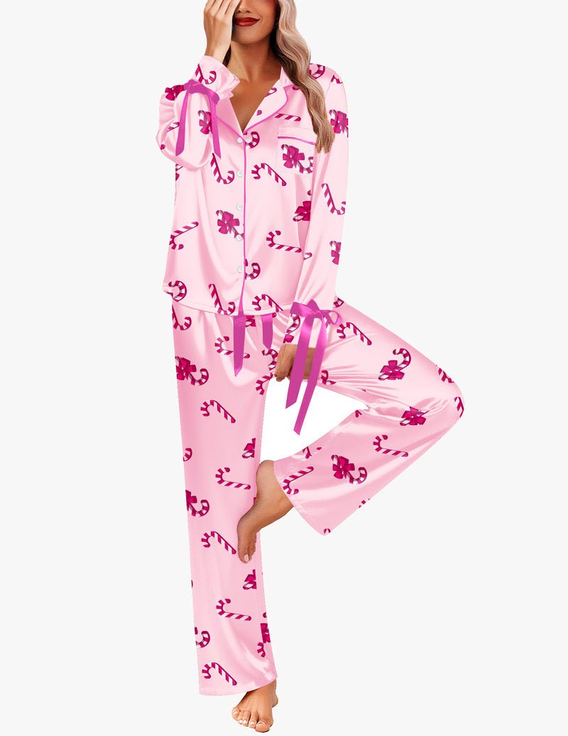 Light pink satin pajama set with dark pink bow and candy print; button-front top