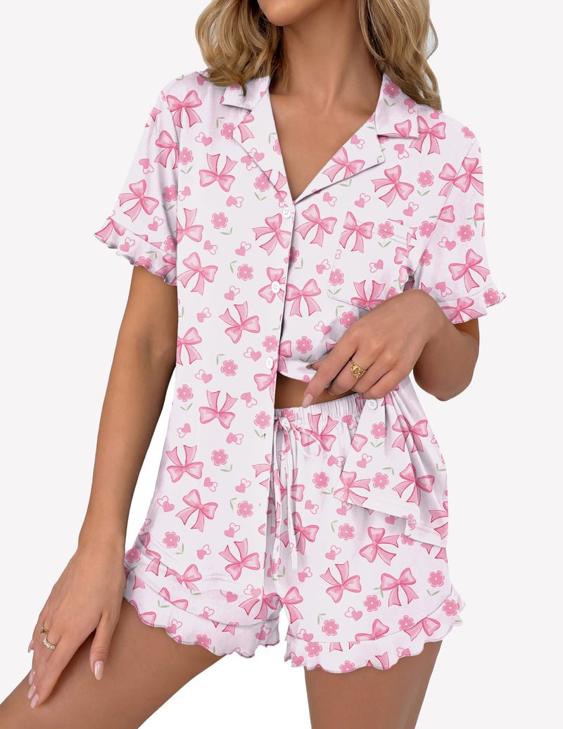 White pajama set with pink bow and flower print: button-up top and ruffle shorts