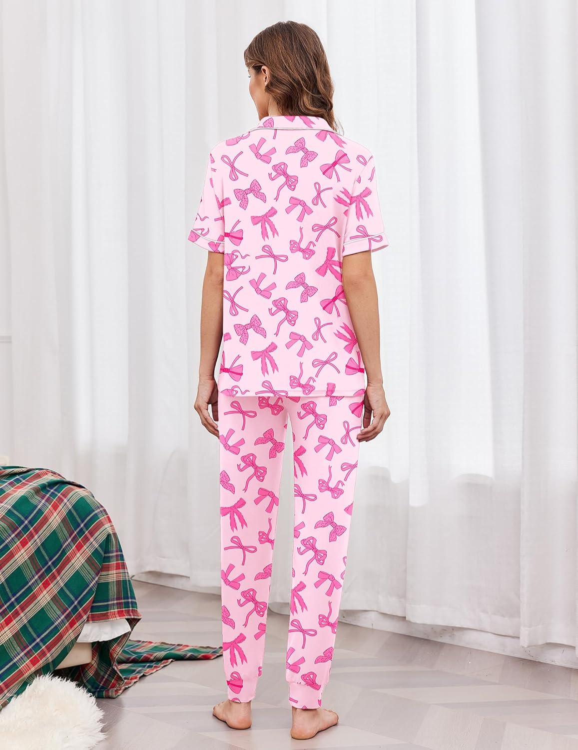 Women's back view light pink bow-print pajama set with white trim and drawstring joggers
