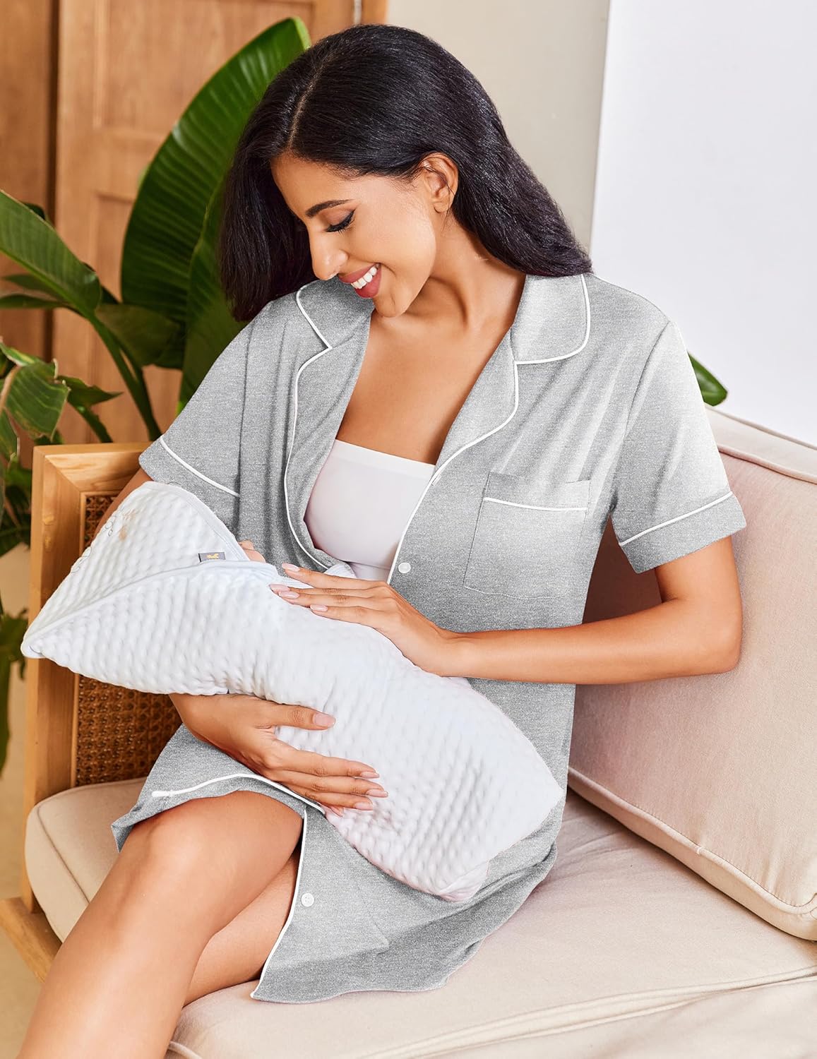 Grey short-sleeve button-down nightshirt with contrast collar, worn while cuddling pillow