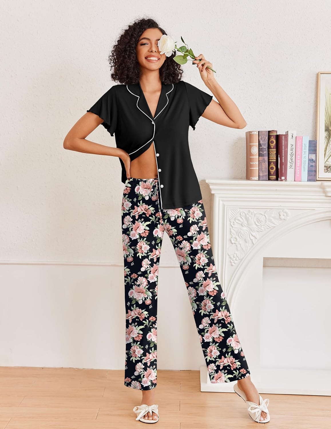 Black button-up pajama top with floral wide-leg pants in pink and light colors