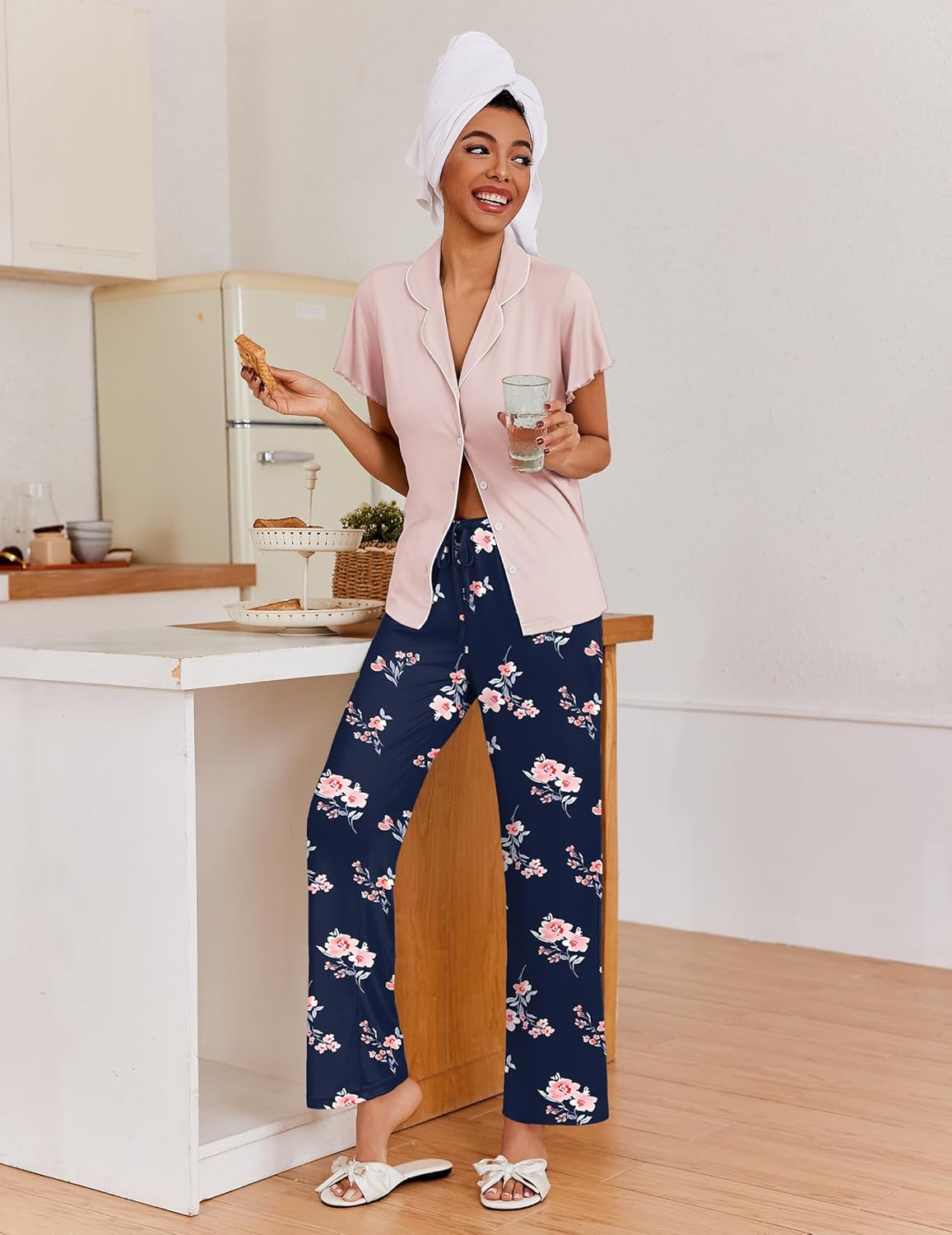 Light pink short-sleeve pajama top with button front and navy floral pajama pants