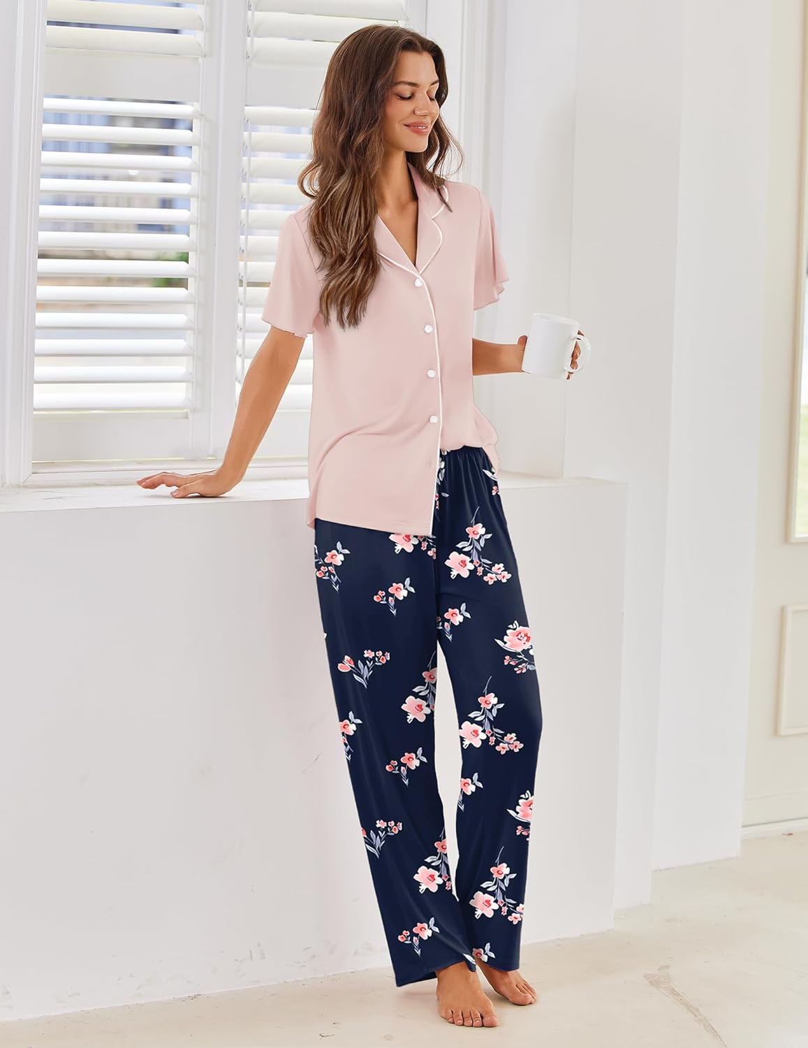 Light pink pajama top with button front over navy floral wide-leg pants