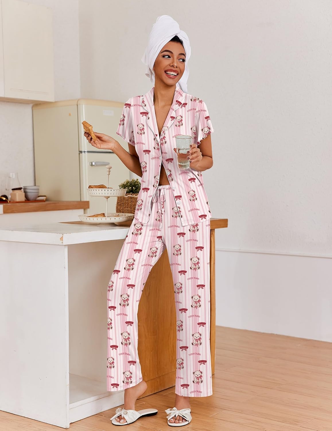 Light pink button-up pajama set with all-over cartoon print and drawstring waist pants