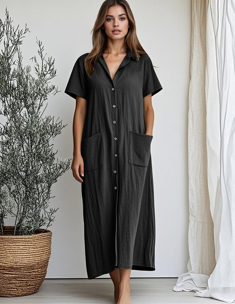 Black cotton shirt dress with short sleeves, button front, collar, and patch pockets.