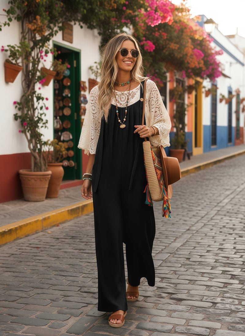 Black wide-leg jumpsuit with bow-tie front and adjustable straps, relaxed boho style