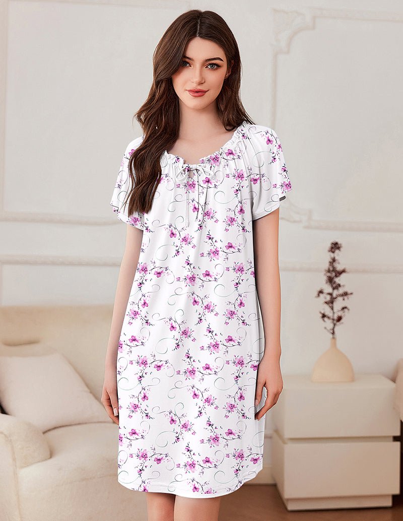 Casual short sleeve pleated dress, white with pink and purple floral print and tie neckline.
