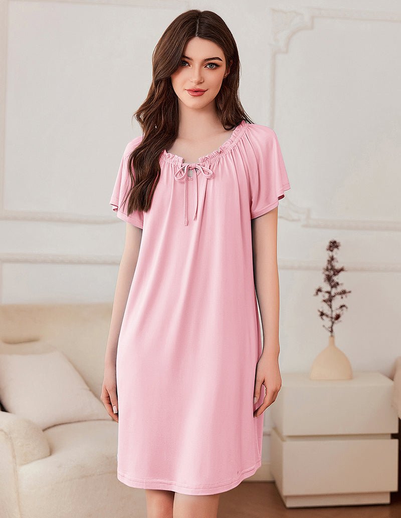 Short-sleeve dress in pale pink with gathered neckline and bow-tie detail