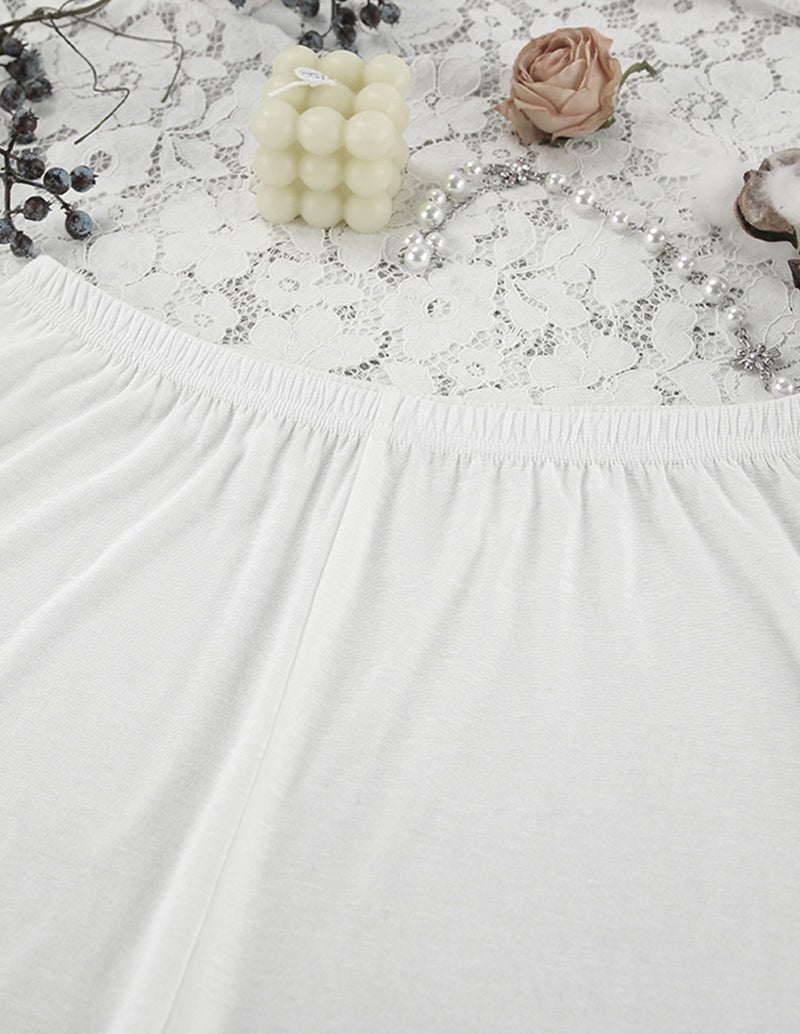 White lightweight pajama top and shorts set with elastic waistband, gathered hem