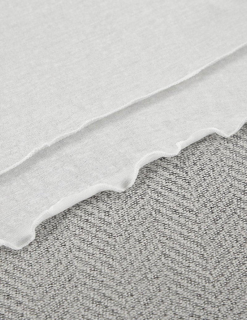 White pajama fabric with scalloped ruffle trim along the hem