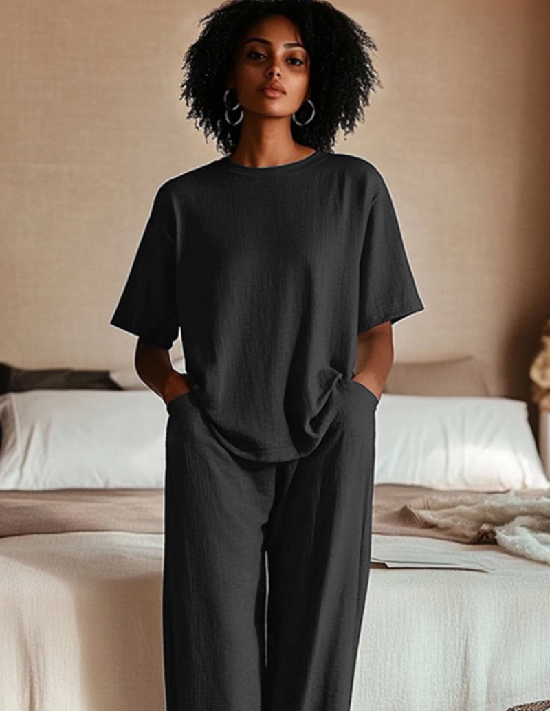 Two-piece pajama set in black with short sleeves and relaxed wide-leg pants