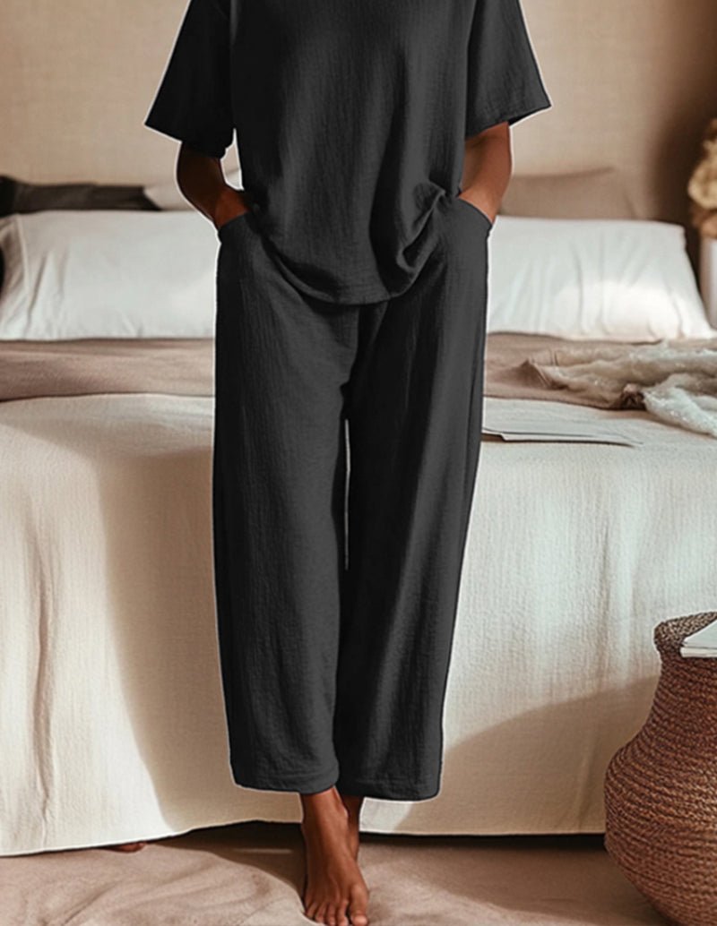 Two-piece pajama set in black with wide-leg pants and short-sleeve top