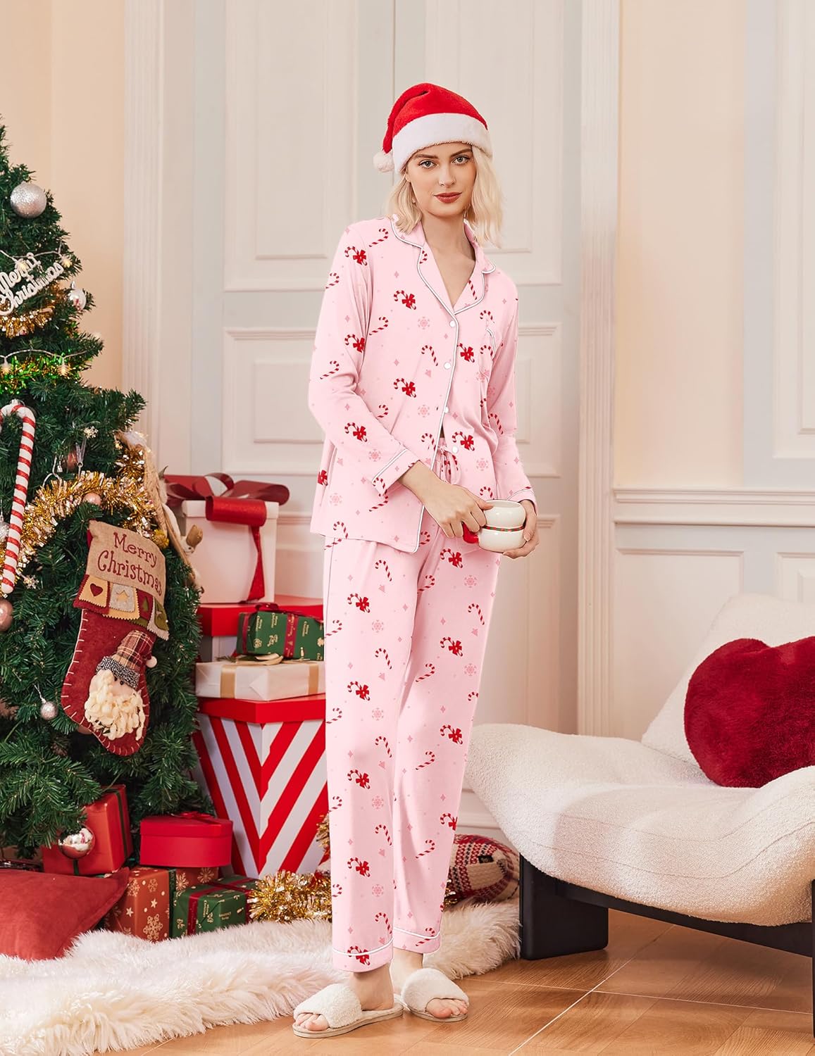 Pink long-sleeve Christmas pajama set with red holiday print, button-front top and pants