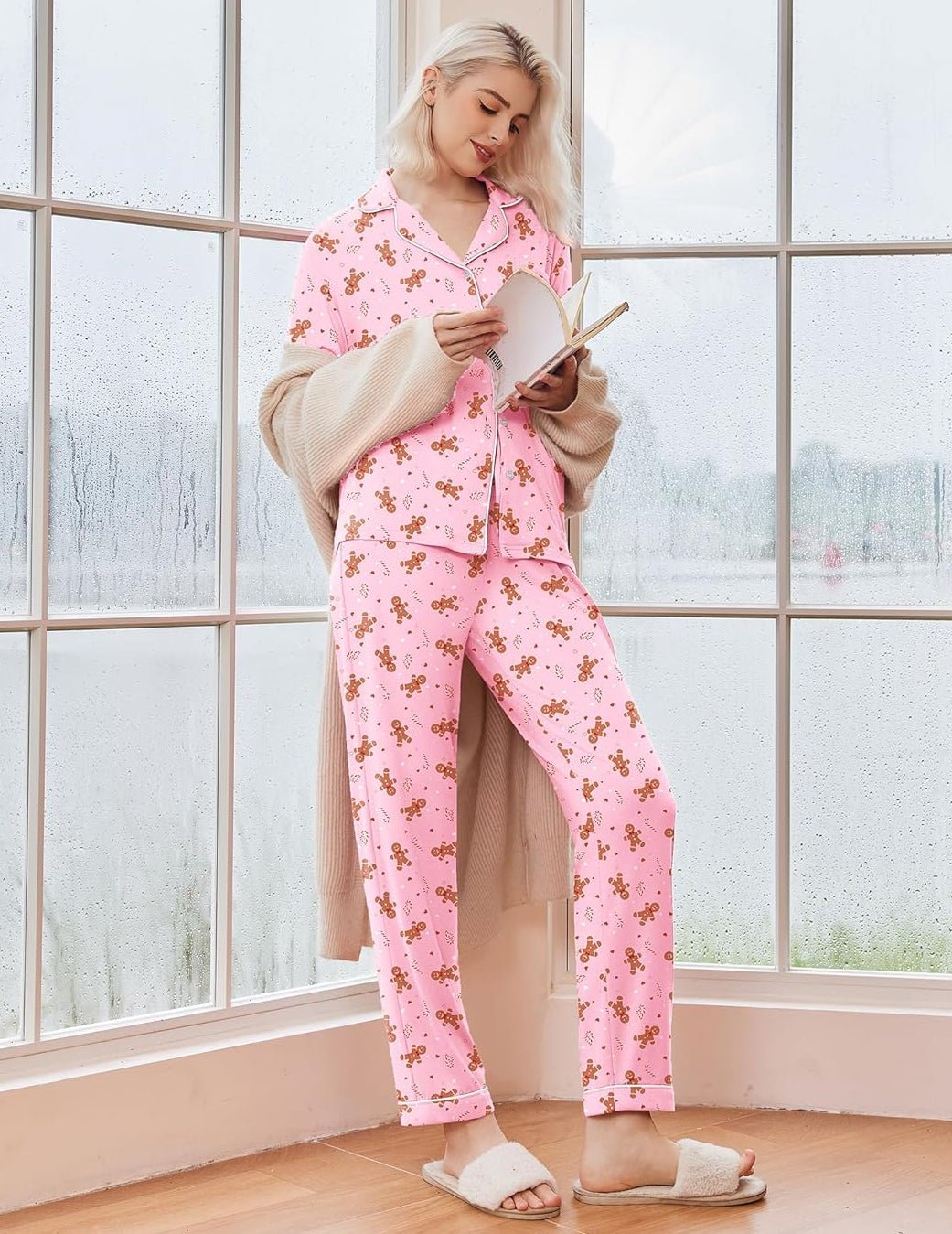 Pink long-sleeve Christmas pajama set with festive print, button-front top and tapered cuffs