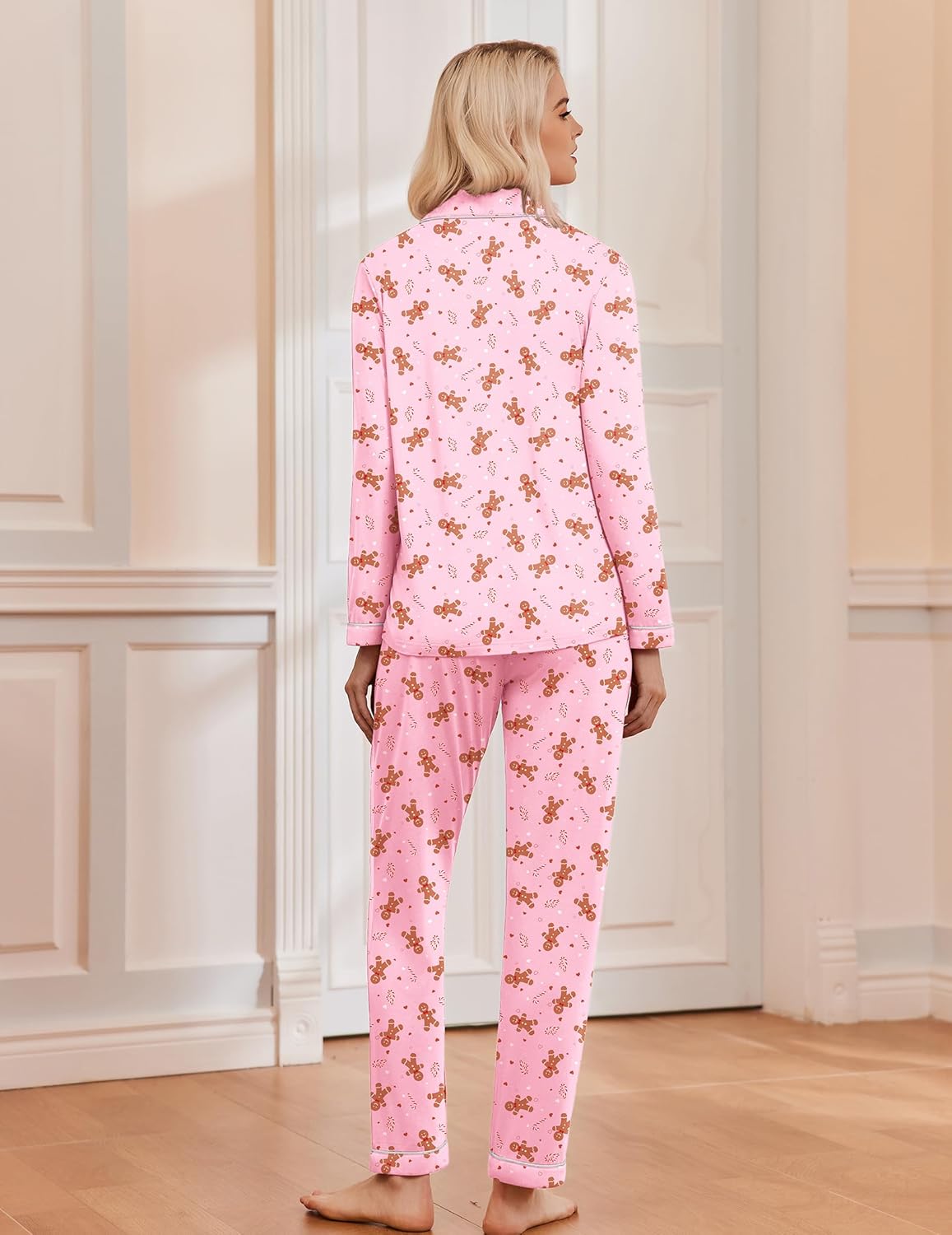 Pink long-sleeve Christmas pajama set with festive gingerbread-style print, full-length pants