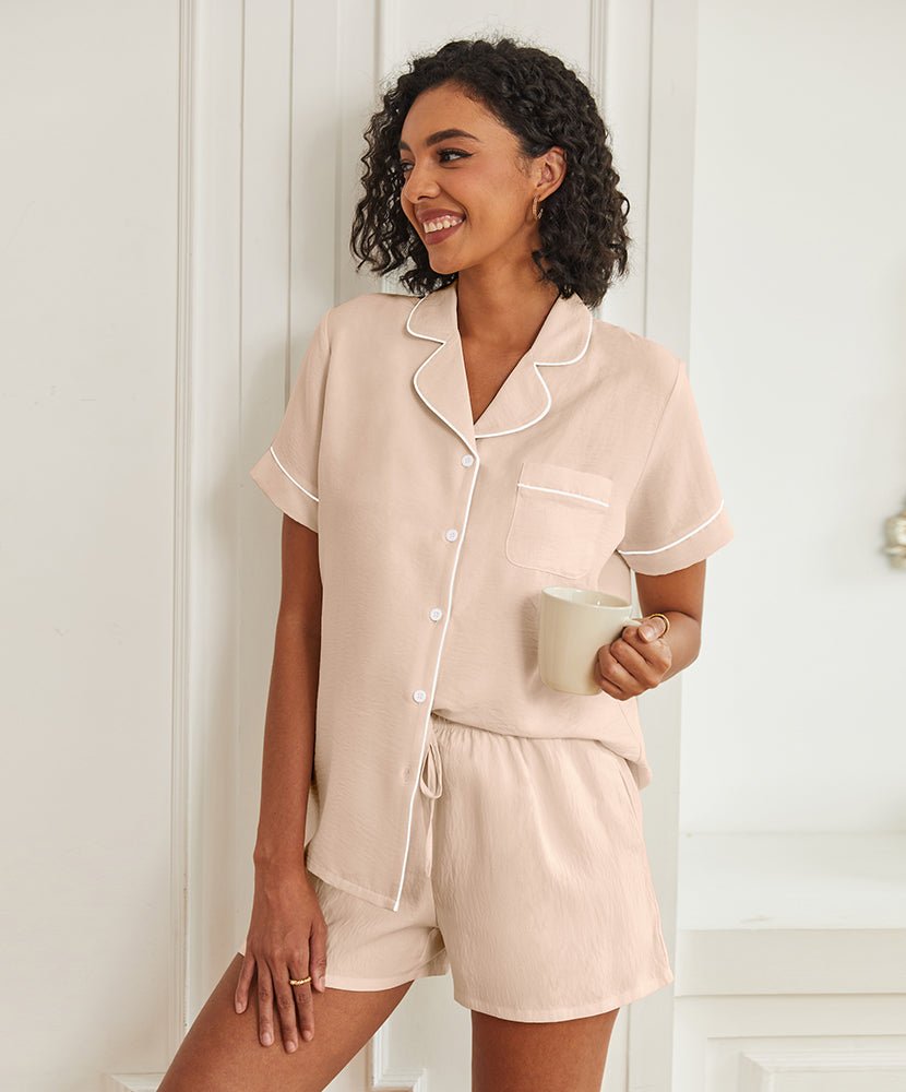 Beige short-sleeve pajama set with button front, piped collar, and drawstring shorts.